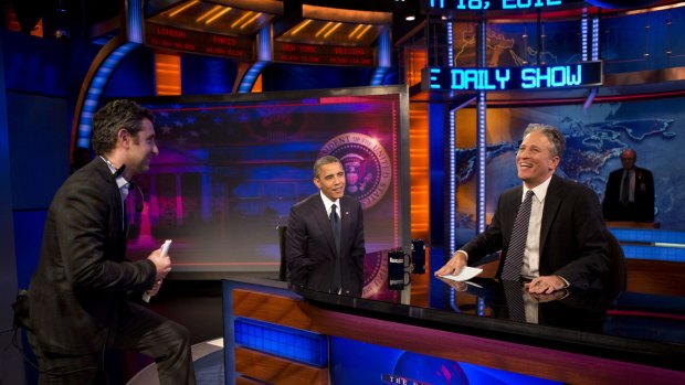 Jon Stewart laughs during a taping break while interviewing US President Barack Obama.