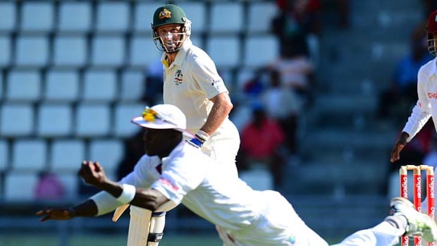 West Indies captain Darren Sammy dismisses Australian batsman Michael Hussey.