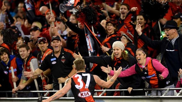 Flying high: Essendon's Kyle Reimers celebrates a goal with Bomber supporters last night.