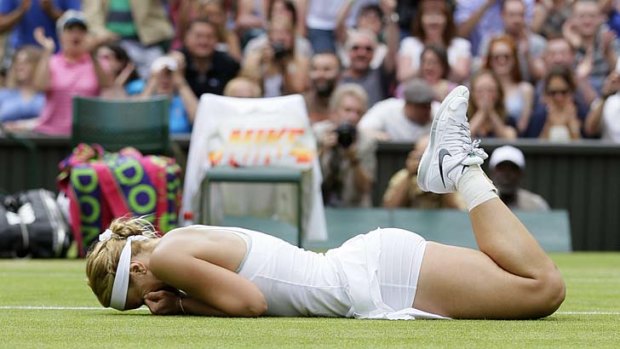 Wonder win: Sabine Lisicki falls to the ground after beating Serena Williams at Wimbledon.