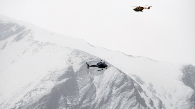 Rescue helicopters fly over the mountainside near Seyne-les-Alpes on Tuesday.