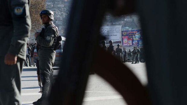 Police keep watch at the Afghan Ministry of Interior after a suicide bomb attack.