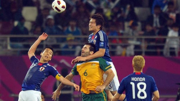 Fierce rivals ...  Daisuke Iwakuma gets a jump on Sasa Ognenovski during the AFC Asian Cup final in Doha last year.