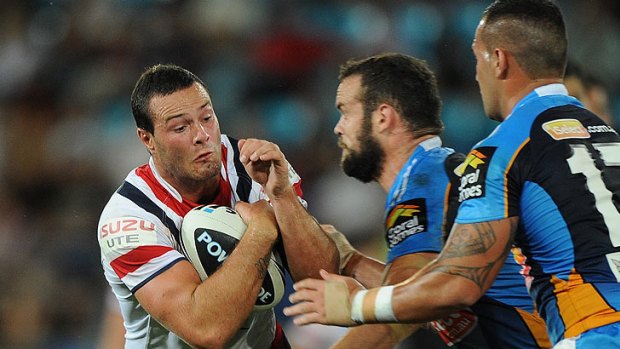 Boyd Cordner of the Roosters is tackled during the round six NRL match between the Gold Coast Titans and the Sydney Roosters at Skilled Park on April 7, 2012 on the Gold Coast, Australia.