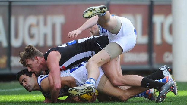 Sandwich: Lachlan Keeffe gets caught between North’s Lindsay Thomas and Taylor Garner.