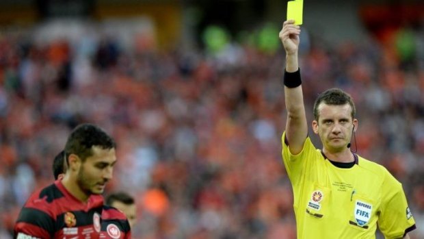 A-League referee of the year, Peter Green, hands out a yellow card Adam D'Apuzzo.