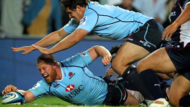 Down and not out: Paddy Ryan scores for the Waratahs.