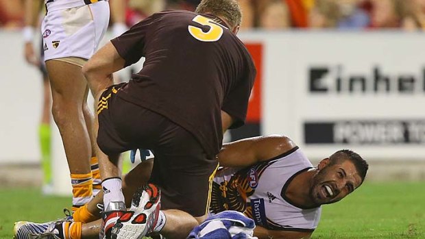 Paul Puopolo receives medical attention after injuring his knee.
