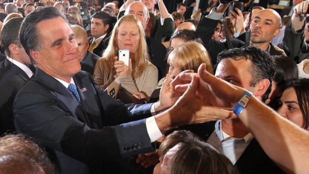 Mitt Romney greets supporters.