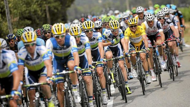 Simon Gerrans of Australia, wearing the overall leader's yellow jersey, rides with his teammates during the fifth stage of the Tour de France.