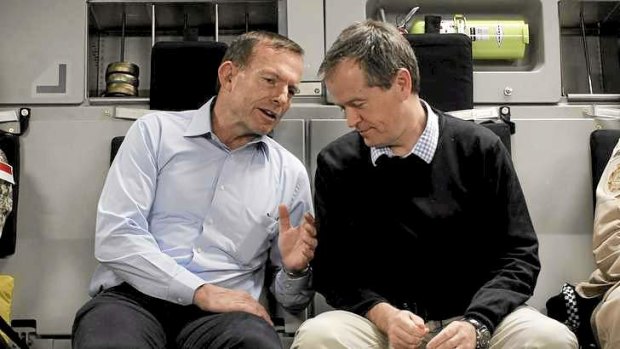 Tony Abbott and Bill Shorten on the flight to Tarin Kowt in Afghanistan. The Prime Minister has paid tribute to defence personnel in his Christmas message.