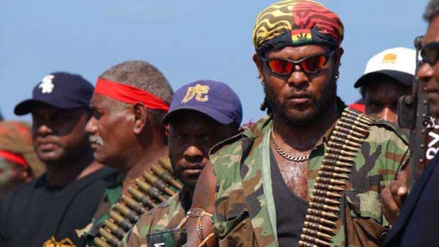 Jimmy ‘‘Rasta’’ Lusibaea and his men surrender weapons and ammunition in 2003 as part of an arms amnesty.