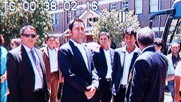Indian cricketers wait outside the gates of Kirribilli House.