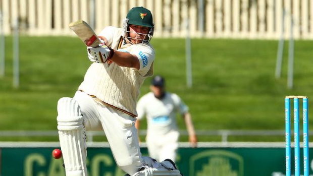 Big challenge: Mark Cosgrove crashes the ball through the covers for Tasmania in a Sheffield Shield match last season.