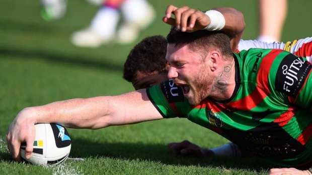 Rub it in: Chris McQueen scores for the Rabbitohs against the Knights.
