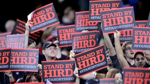 Essendon supporters with Stand by Hird signs.