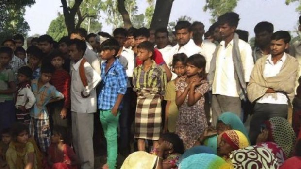 Protest against police ... Indian villagers gather around the bodies of two teenage sisters hanging from a tree in Katra village in Uttar Pradesh state, India.