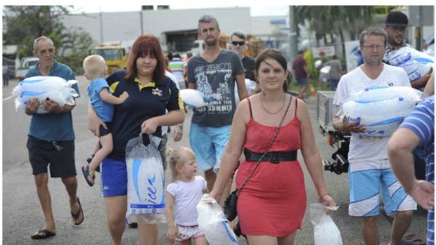 Townsville residents stock up on ice as they face a third day without electricity.