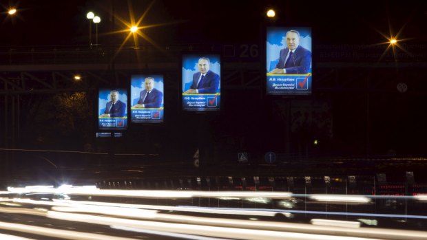 Traffic flows past election posters of Kazakhstan's President Nursultan Nazarbayev on Tuesday.