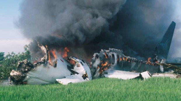 Smoke pours from the wreckage of the Garuda plane crash at Yogyakarta airport on March 7, 2007.