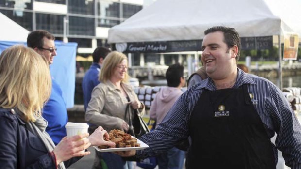 Meet 'n' eat ... ''banana bread man'' Theo Gounakis gives out samples at the Growers' Market.