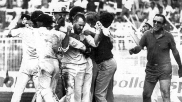 Manager Bob Simpson (right) runs onto the field to congratulate Greg Matthews in the tied Madras Test in 1986.