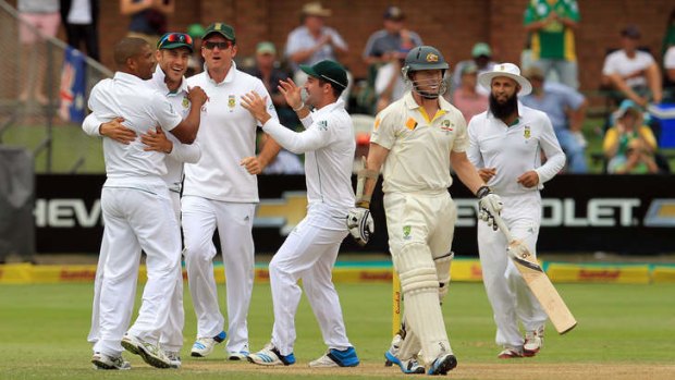 Early wicket ... Australia's batsman Chris Rogers, second from right, leaves the field after dismissed by South Africa's bowler Vernon Philander, left, for 5 runs.