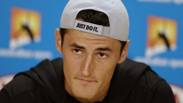 Australia's Bernard Tomic listens to a question at a pre-tournament press conference for the Australian Open.