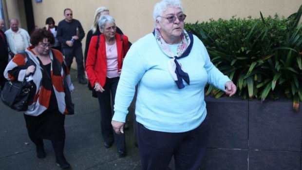 Ellyse Valkay, whose mother died in the Quakers Hill Nursing Home fire, walks into Glebe Coroners Court on Monday with relatives of other victims.