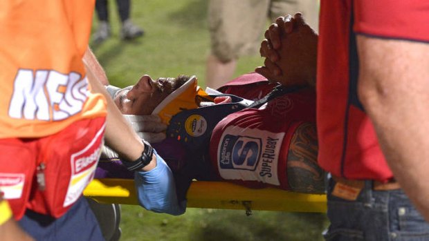 Quade Cooper is stretchered off the ground wearing a neck brace.