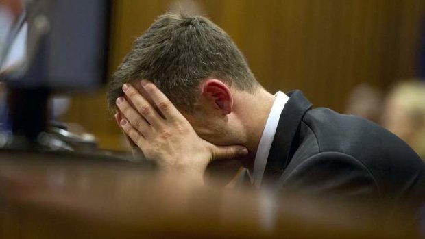 In the dock: Oscar Pistorius reacts during his trial at the high court in Pretoria on Monday.