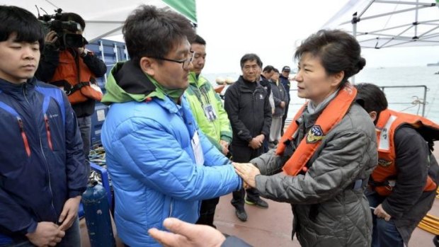 Park Geun-hye, right, meets a relative of a missing passenger of the Sewol ferry.