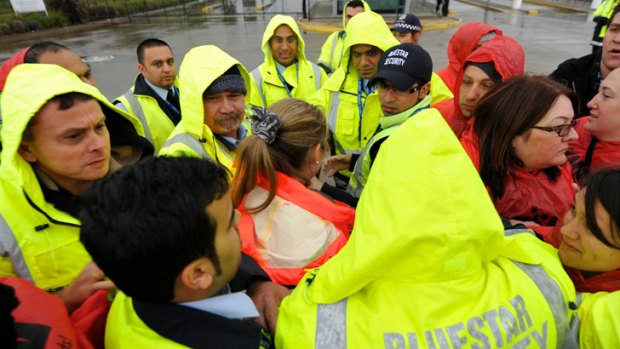 Toll's head of Human Resources, Andrea Ryan, is surrounded as she attempts to cross the picket line.