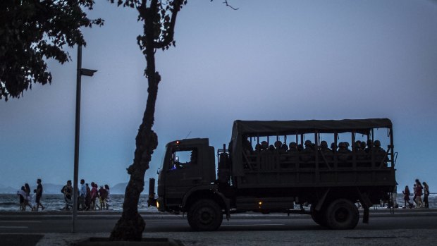 Military soldiers sit in a truck while patrolling the streets near Copacabana beach in Rio de Janeiro, Brazil.