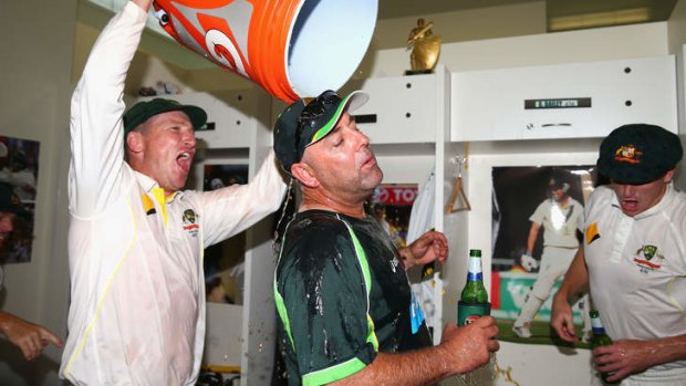 This calls for a refreshment: Brad Haddin tips a bucket of energy drink over Lehmann.