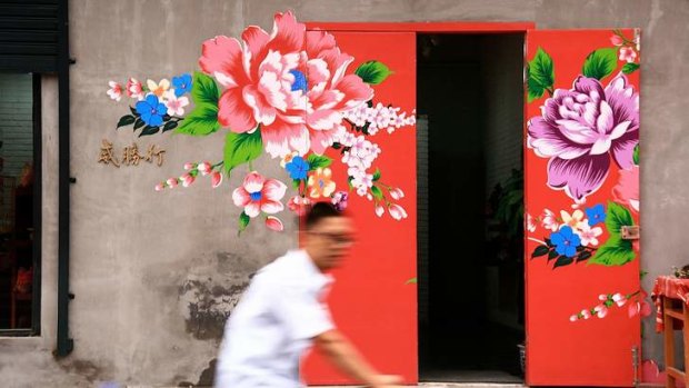 Floral graffiti adorns a doorway.