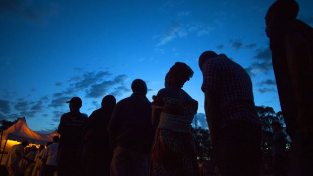Voters stand in line at the Kibra Social Grounds polling station in Nairobi on March 4, 2013 during the elections.