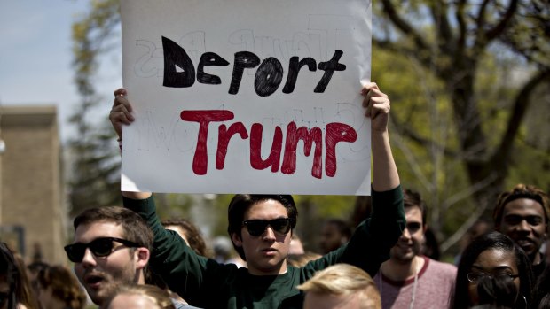 A demonstrator holds a "Deport Trump" sign at West Chester University in West Chester, Pennsylvania in April. 