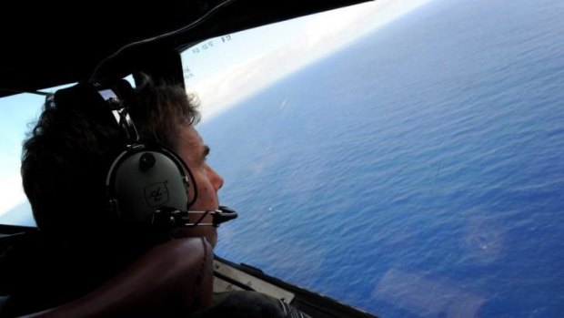 No confirmed debris ... Co-pilot and Squadron Leader Brett McKenzie of the Royal New Zealand Airforce P-3K2-Orion aircraft hunts for a sign of MH370.