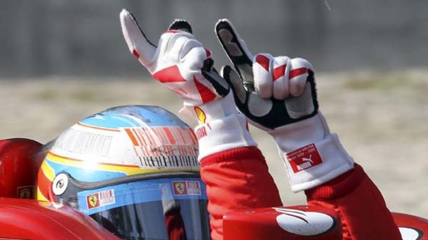 Fernando Alonso of Spain celebrates after winning the Italian Grand Prix.
