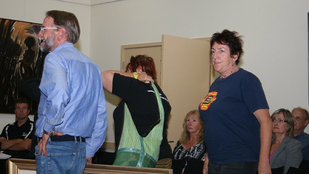 Desal spray ... Protesters disrupt attempts by builder Theiss Degremont's John Barraclough to give the painting to Bass Shire Council.