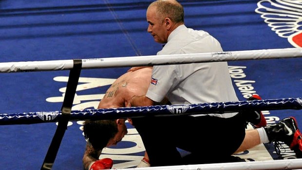 Ricky Hatton is consoled by the referee after being knocked down.