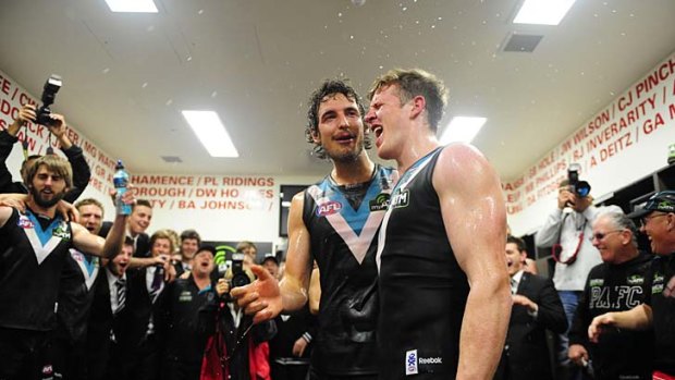 Out on a high: Port players celebrate their final-round victory over Melbourne at Adelaide Oval yesterday.
