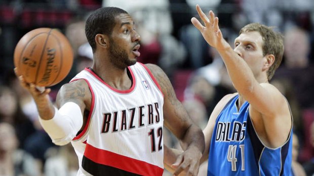 Portland Trail Blazers forward LaMarcus Aldridge looks to pass against Dallas Mavericks forward Dirk Nowitzki, the only player in the NBA with a better mid-range jump shot.