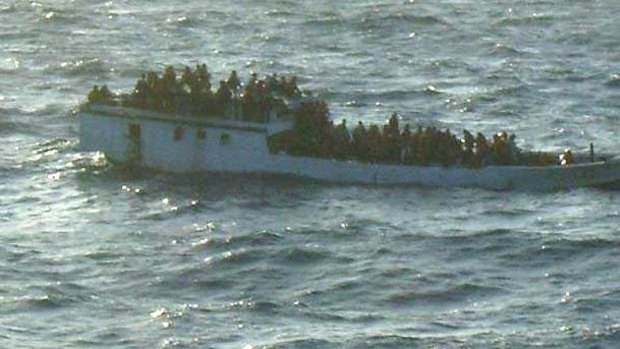 The overloaded boat before it capsized, pictured by  the merchant vessel  MV Bison Express mid-morning.