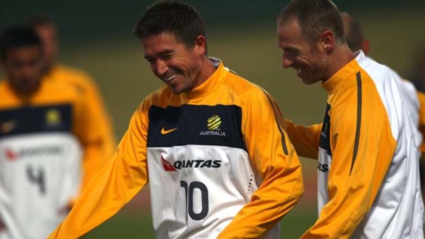 Smiling assassin? ... Harry Kewell shares a laugh with defender Craig Moore at training this week. A fit again Kewell will be crucial to Australia?s chances of defeating Ghana.