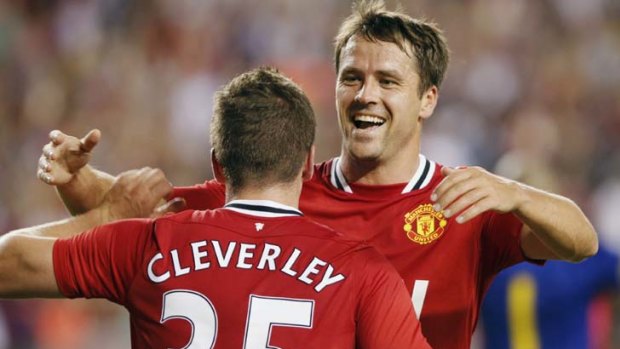 Michael Owen celebrates his goal against Barcelona with teammate Tom Cleverley.