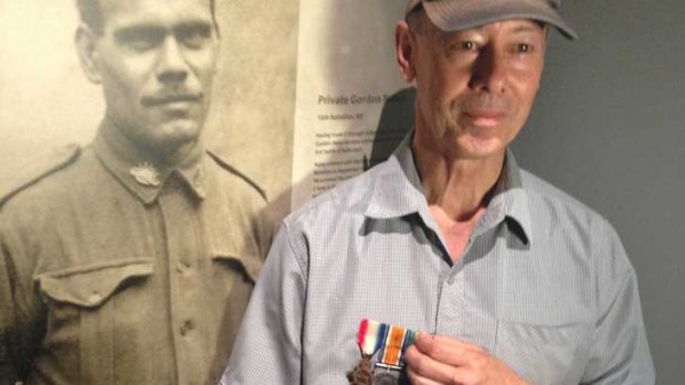 Michael Laing with a photo of his grandfather Gordon Naley and his war medals.