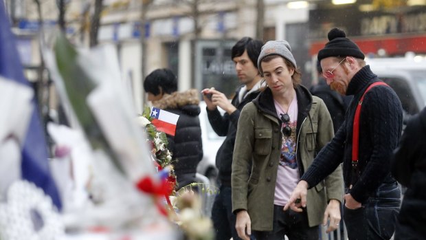 In this December 8 photo, members of the band Eagles of Death Metal, Jesse Hughes, right, and Julian Dorio pay their respects to 89 victims who died in the Novermber 13 attack at the Bataclan concert hall in Paris.