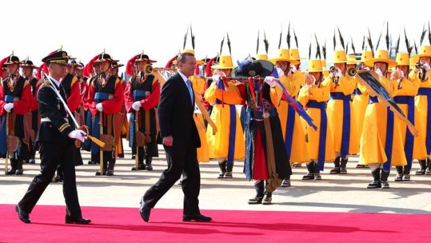 Roll out the colour: Tony Abbott is welcomed in a ceremony at Seoul Airbase, South Korea on Tuesday.